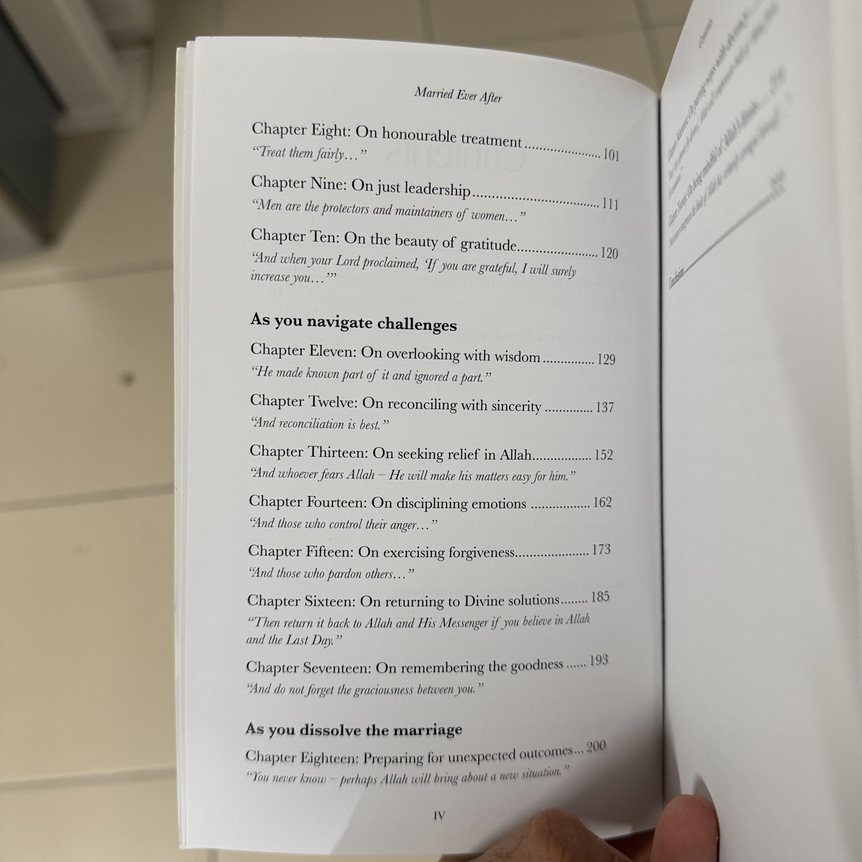 Open book showing a table of contents with text on a wooden surface.