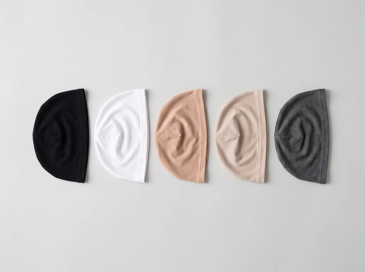 Five hijab undercaps in a row in black, white, nude, beige and charcoal