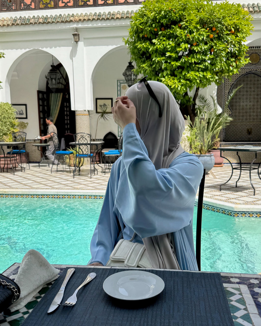 Hijabi Woman wearing umrah abaya in sky blue