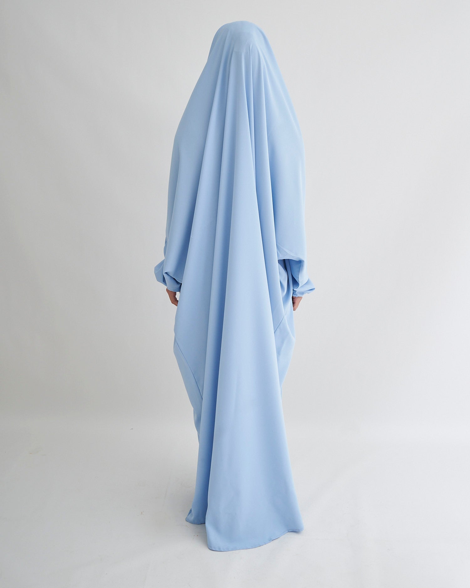 Light blue dress with long sleeves on a plain background