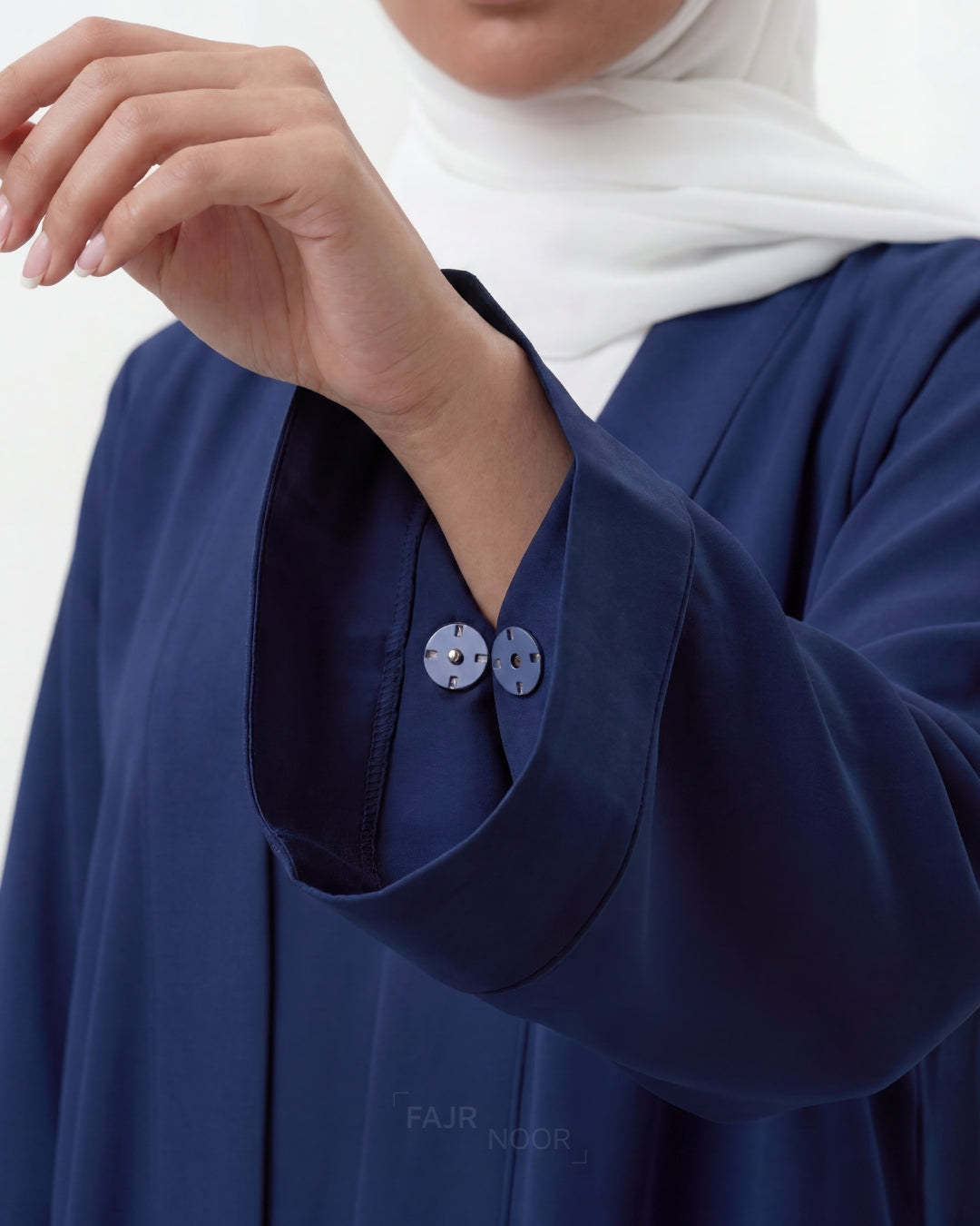 Navy blue garment with buttons, worn by a person, on a white background.