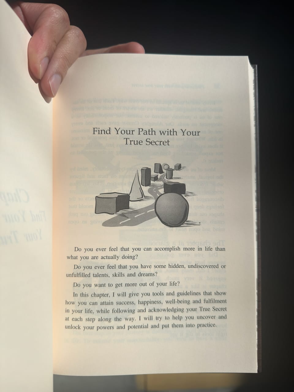 Open book with text and illustration on a dark background