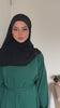 Woman wearing the Fajr Noor Khatijah Abaya in emerald with a black hijab