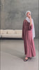 Woman wearing the Fajr Noor Khatijah Abaya in pink with a white hijab, taking a mirror selfie