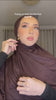 Woman trying on a chocolate brown Fajr Noor premium modal hijab for the first time, styling it over her head and shoulders