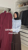 Woman getting ready for the mosque, holding up the Fajr Noor Khatijah Abaya in maroon with a berry chiffon khimar