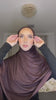 Close-up of a woman wearing a chocolate brown Fajr Noor premium modal hijab, draped and wrapped around her face and shoulders
