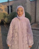 woman wearing purple abaya and showing off her outfit.