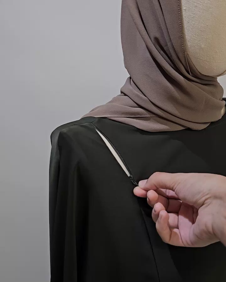 Close-up of the Fajr Noor nursing-friendly abaya in olive showing the concealed zip breastfeeding access