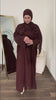 Woman trying on the Fajr Noor Aya Linen Abaya in dark brown with a matching hijab, in front of a mirror