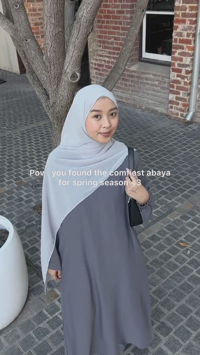 grey abaya hijab wearing woman