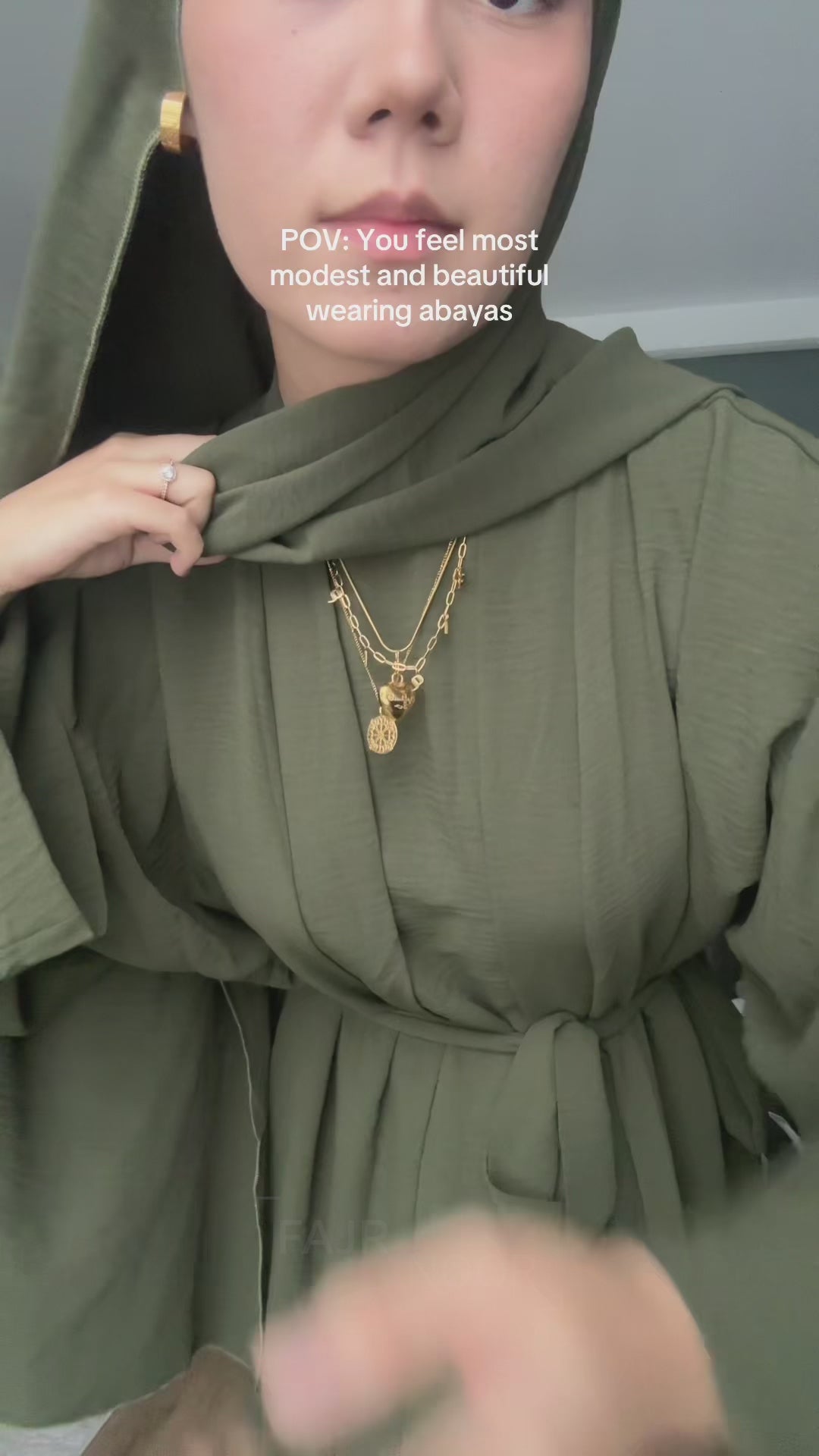 Woman wearing the Fajr Noor 3-piece Crinkle Abaya set in khaki green, belted at the waist