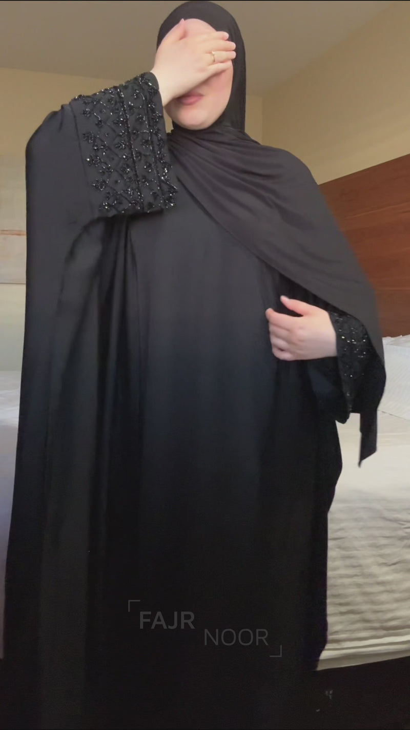 Woman wearing the Fajr Noor Maryam Abaya in black with embellished sleeve cuffs and a matching hijab